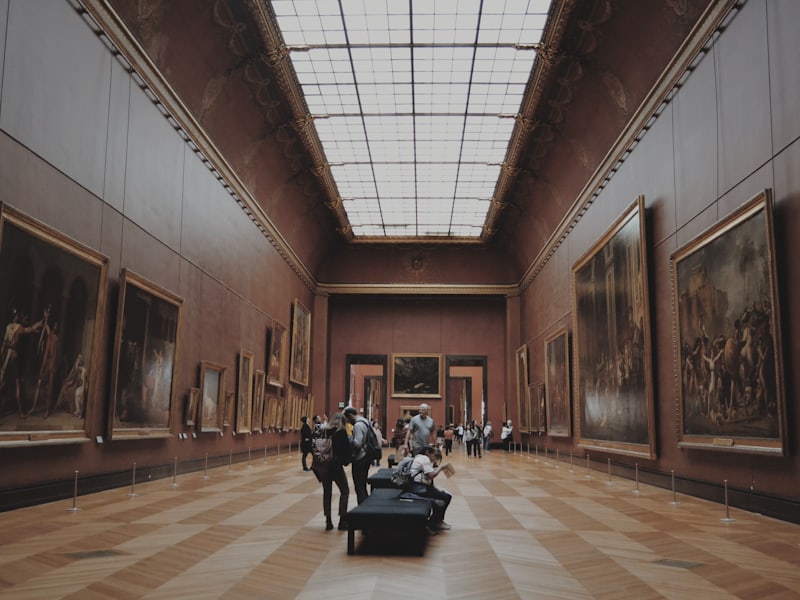 A curator leading a small group of members through a gallery
